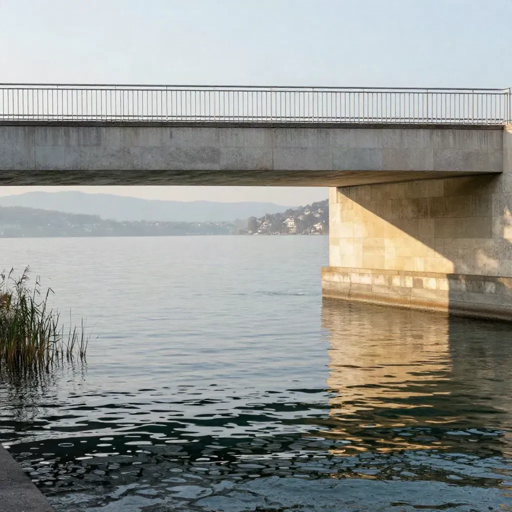 Zurich lakeside edge with glowing alpine line, calm water, and modern stone-and-glass waterfront.